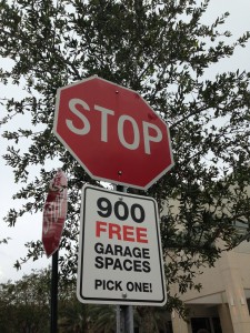 Stop sign reads 900 free garage spaces pick one