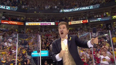 An animated gif of Boston Bruins anthem singer Rene Rancourt, wearing his usual black tux with a shiny gold vest, holding up four fingers for the crowd then vigorously pumping his fist four times.